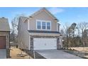 Two-story house with stone and shingle accents, two-car garage, and landscaping at 2033 White Cypress Ct # Kh06, Charlotte, NC 28216