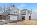 Two-story house with stone and shingle accents, two-car garage, and landscaping at 2033 White Cypress Ct # Kh06, Charlotte, NC 28216