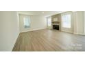 Spacious living room featuring a stone fireplace and hardwood floors at 2033 White Cypress Ct # Kh06, Charlotte, NC 28216