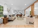 Spacious living room featuring light walls and a stylish geometric feature wall at 3417 Chilham Pl, Charlotte, NC 28226