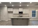 Modern kitchen with white cabinets, granite countertops, and stainless steel appliances at 401 Imperial Way # 25, Albemarle, NC 28001