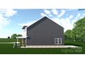 Side view of a two-story home with dark siding, a covered porch, and lush green landscaping at 4615 Yellow Poplar Ln, Concord, NC 28025