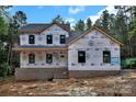 New two-story home under construction with visible framework and brick foundation at 4641 Yellow Poplar Ln, Concord, NC 28025