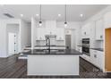 Modern kitchen with white cabinets, dark countertops, and island at 1194 Lost Cove Rd, Indian Land, SC 29707