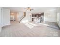 Bright and airy living space with stairs, open layout to the kitchen, and ample natural light at 159 Rubys Way # 35, Oakboro, NC 28129