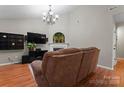 Cozy living room featuring a fireplace, flat screen tv, with a brown sofa at 307 Tara Elizabeth Pl # 22, Kannapolis, NC 28083