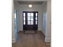 Light and bright entryway with hardwood floors and a view into the living room at 405 19Th Avenue Nw Cir, Hickory, NC 28601