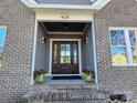 Dark stained front door entry with brick and board and batten exterior at 405 19Th Avenue Nw Cir, Hickory, NC 28601