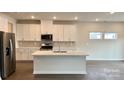 A modern kitchen featuring white cabinets, stainless steel appliances, and a large island at 148 Shepherds Landing Dr, Mooresville, NC 28115