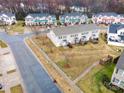 An aerial view of a neighborhood featuring well-maintained lawns, neat landscaping, and paved roads at 1708 Holliford Ct, Charlotte, NC 28215