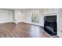 Bright living room with fresh paint, fireplace, and gleaming floors at 2514 Cranbrook Ln # 9, Charlotte, NC 28207