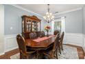 Formal dining room with a large wooden table and hutch at 4813 Chesney Nw St, Concord, NC 28027