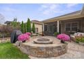 Outdoor patio with fire pit, seating area, and screened porch at 5003 Looking Glass Trl, Denver, NC 28037