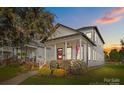 Charming two-story home featuring a covered porch, American flag, and well-manicured landscaping at 511 E Main St, Rock Hill, SC 29730