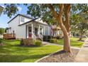 Inviting two-story home featuring a charming front porch, American flag, and well-maintained yard at 511 E Main St, Rock Hill, SC 29730