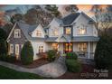 Festive two-story home with stone accents, covered porch adorned with holiday decorations, and manicured landscaping at 9267 Egret Rdg # 41, Belmont, NC 28012