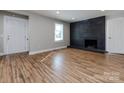 Living room featuring hardwood floors and a modern fireplace at 406 Harris Ln, Monroe, NC 28112