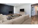 Living room with comfy seating and a modern fireplace at 406 Harris Ln, Monroe, NC 28112