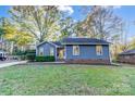Charming blue home with well-manicured lawn and mature trees in a quiet neighborhood at 13446 Idlefield Ln, Matthews, NC 28105