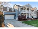 Charming two-story home featuring a double porch, two-car garage, and spacious driveway at 428 Vintage Hill Ln, Huntersville, NC 28078