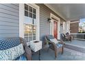 Inviting front porch with comfortable seating and stylish decor, perfect for relaxing outdoors at 428 Vintage Hill Ln, Huntersville, NC 28078