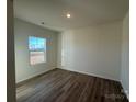 Bright bedroom with a large window and light brown laminate flooring at 168 Salem Springs Ln, Statesville, NC 28625