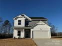 Two-story house with gray and white siding, white garage door, and landscaping at 168 Salem Springs Ln, Statesville, NC 28625
