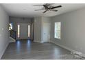 Bright, open-concept living room featuring vinyl floors, large windows, and modern ceiling fan at 202 Fostoria Pl # 78B, Albemarle, NC 28001