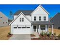 Beautiful two-story home featuring white and gray siding, a covered porch, and a two-car garage at 2234 Millennium Dr # 84, Lancaster, SC 29720