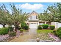 Charming two-story home with a well-maintained yard and beautiful flowering trees at 310 Rose Garden Ct, Rock Hill, SC 29732