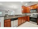 Well-lit kitchen featuring granite countertops, stainless steel appliances and wood cabinetry at 310 Rose Garden Ct, Rock Hill, SC 29732