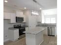 Bright kitchen featuring white cabinets, granite countertops, a kitchen island and stainless steel appliances at 1647 Davis Farm Rd, York, SC 29745