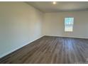 Simple bedroom with gray vinyl flooring and a window at 174 Salem Springs Ln, Statesville, NC 28625