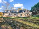 Large backyard with patio, lush lawn, mature trees, and full fencing for privacy at 204 Jonas Dr, Lincolnton, NC 28092