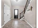 Welcoming foyer with tile flooring, staircase, and front door with decorative glass panel at 204 Jonas Dr, Lincolnton, NC 28092