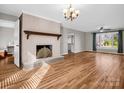 Spacious living room featuring hardwood floors, fireplace with mantel, and plenty of natural light at 204 Jonas Dr, Lincolnton, NC 28092