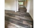 Inviting living room area with luxury vinyl plank flooring, leading to additional living spaces with abundant natural light at 282 New Salem Rd, Statesville, NC 28625