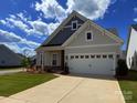 Beautifully maintained single-Gathering home features neutral siding, a lush green lawn, and a two-car garage at 405 Northgate Blvd, Indian Trail, NC 28079