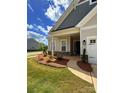 Inviting home boasts well-kept lawn, landscaping, covered entryway, and attached two-car garage at 405 Northgate Blvd, Indian Trail, NC 28079