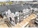 Modern townhome exteriors boast a gray and white color scheme, individual entrances, and balconies at 6025 Countess Dr # 54, Charlotte, NC 28217