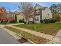 A suburban home with manicured lawn and landscaping on a tree-lined street at 7108 Kinley Commons Ln, Charlotte, NC 28278