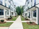 Well-manicured community featuring sidewalks and landscaping creating a welcoming environment at 13024 Moon Rd # 44, Charlotte, NC 28277