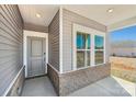 Welcoming front porch with stylish gray door, brick accents, and ample natural light at 1333 Morehead Dr, Salisbury, NC 28144