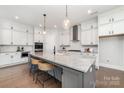 Bright kitchen features white cabinets, subway tile backsplash, stainless steel appliances, and granite countertops at 267 Triple Ponds Ct # 11, Clover, SC 29710