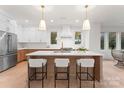 Modern kitchen with island, stainless steel appliances, and light wood cabinets at 2911 Hilliard Dr, Charlotte, NC 28205