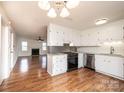 Bright kitchen features white cabinets, granite countertops and stainless-steel appliances at 123 23Rd Nw St # E, Hickory, NC 28601