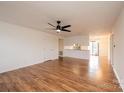 Spacious living room with wood-look flooring, fan, and fireplace at 123 23Rd Nw St # E, Hickory, NC 28601