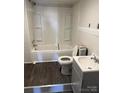 Clean bathroom with a bathtub, toilet, and vanity at 1808 Taylor Ave, Charlotte, NC 28216