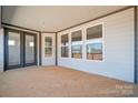 Covered back porch with ample natural light provided by several large windows at 127 Jentri Way, Mooresville, NC 28115