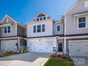 New construction townhome with a two car garage, stone accents and a welcoming front door at 153 Halite Ln, Waxhaw, NC 28173